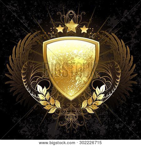 Golden Shield Decorated With A Pattern, Wings, Stars And Golden Laurel Branches On A Dark Background