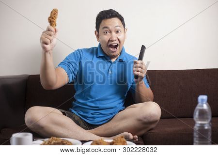 Asian Man Watching Soccer On Tv
