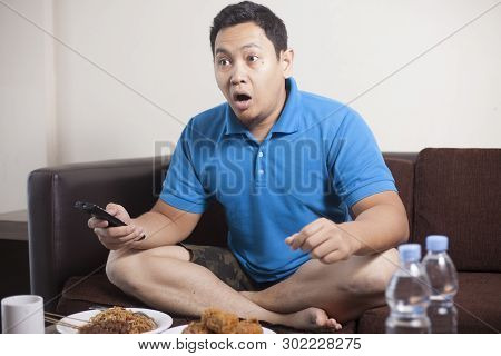 Asian Man Watching Soccer On Tv