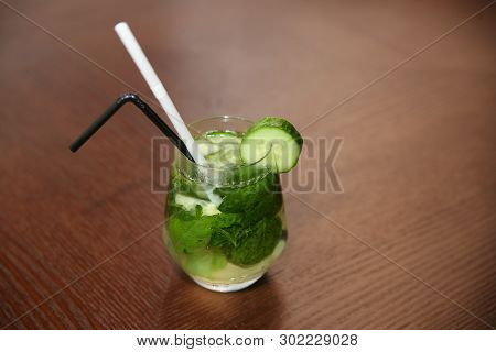 Cucumber Cocktail With Ice Cobe On Wood Background