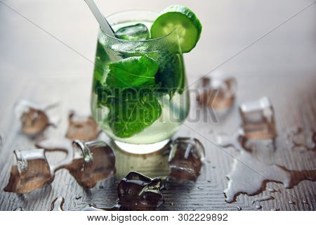 Cucumber Cocktail With Ice Cobe On Wood Background
