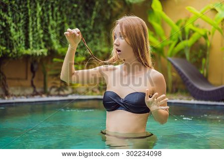 Frustrated Young Woman Having A Bad Hair In The Pool. Due To The Fact That Chemicals In The Pool
