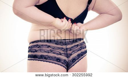 Fat Woman Wearing Black Lingerie Bra And Panties Back View. Plus Size Female Opening Taking Off Or P