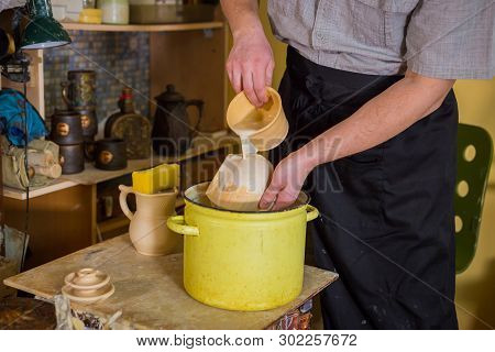 Professional Male Potter Preparing Ceramic Wares For Burning In Pottery Kiln With Milk - Old Russian