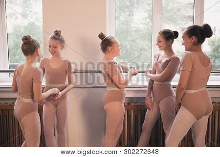 Young Graceful Female Ballet Dancers Dancing At Training Studio. Beauty Of Classic Ballet. Girls Res