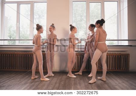 Young Graceful Female Ballet Dancers Dancing At Training Studio. Beauty Of Classic Ballet. Girls Res