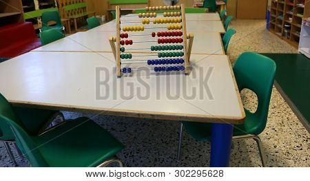 School Classroom With Wooden Abacus Above The Table To Teach Children To Count