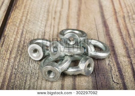 Ring Nuts, Zinc Plated On Wooden Background