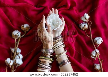 Female Wrists Painted With Traditional Indian Oriental Mehndi Ornaments By Henna. Hands Dressed In B