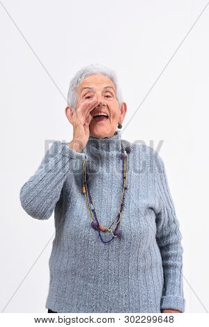 Senior Woman Putting A Hand In Labo And Is Screaming On White Background