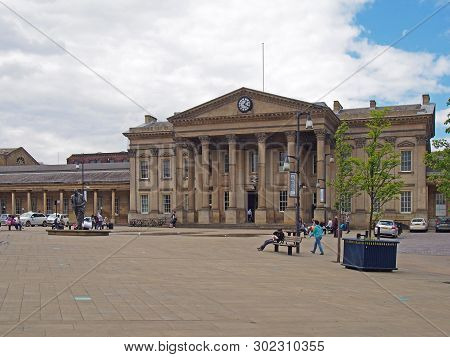 Huddersfield, Yest Yorkshire, United Kingdom - 20 May 2019: People And Taxis In Saint Georges Square