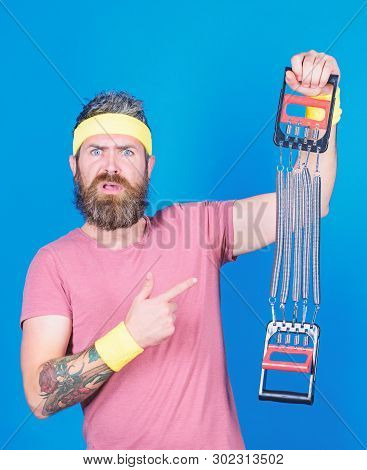 Athlete Workout With Expander. Sportsman Training Stretching Expander. Man Bearded Athlete Exercisin