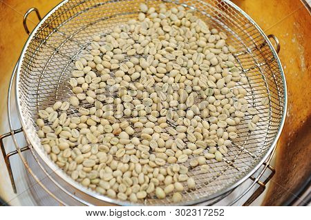 Homemade Roast Of Green Coffee Beans In Aerogrill. Top View