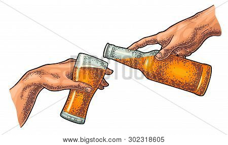 Male Finger Pouring Beer From Bottle Into Glass. The Creation Of Adam.