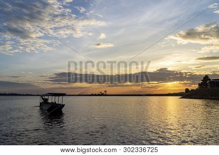 Passenger Boats Across The Side Of The Dam. Evening Atmosphere Along The Water In The Dam. Sailing B