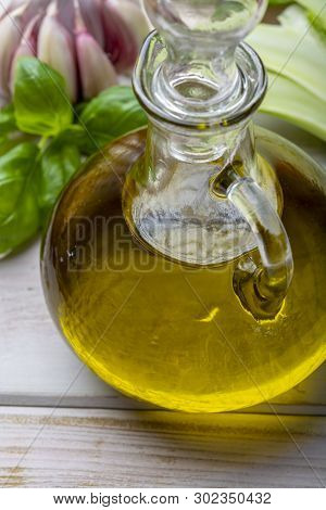 Virgin Natural Olive Oil Is Glass Bottle, Served With Traditional Mediterranean Food