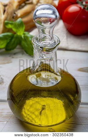 Virgin Natural Olive Oil Is Glass Bottle, Served With Traditional Mediterranean Food