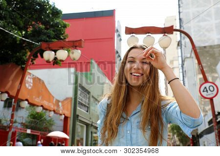 Beautiful Smiling Girl Walking In Sao Paulo Japanese Neighborhood Liberdade, Sao Paulo, Brazil