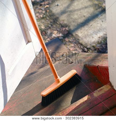 A Mop Keeping A Door Half Open To The Yard, Outdoor Shot