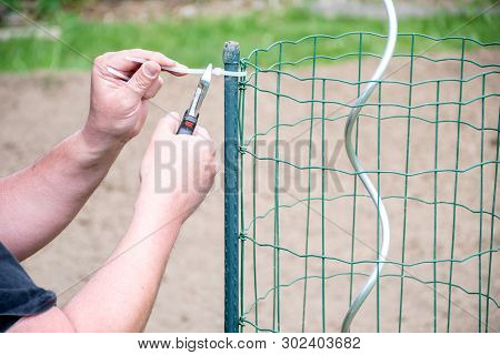 Gardening Handman Working In Garden To Preparing Garden With Cutting,and Tight Plastic With Grill To