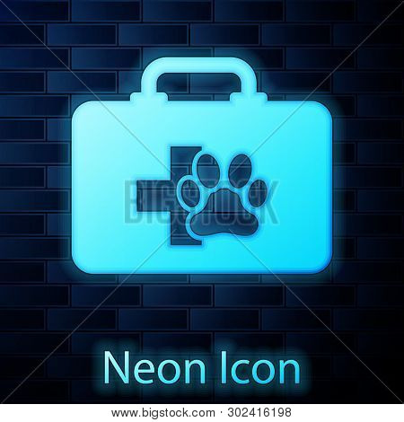 Glowing Neon Pet First Aid Kit Icon Isolated On Brick Wall Background. Dog Or Cat Paw Print. Clinic 