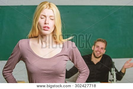 Stumbling Through A Lesson. Cute Woman Standing In Classroom With Teacher. University Or College Stu
