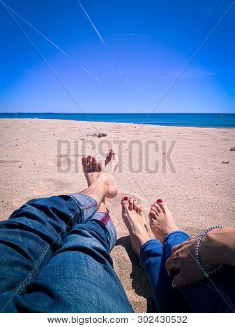 Vacation Holidays. Man And Woman Feet Closeup Relxing On Beach On Sunbed Enjoying Sun On Sunny Summe