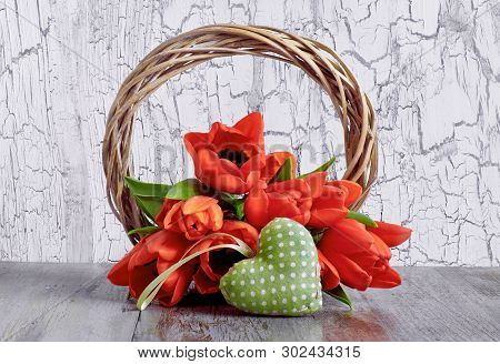 Spring Decoration With Wooden Wreath, Red Tulips And Stugged Heart On White Cracked Background.
