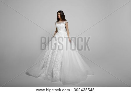 Beauty Young Woman In Long White Princess Wendding Dress, With Luxury Make Up, Poses Standing, Isola