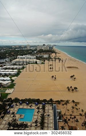 Sealine And Sand Beach With Pool On Cloudy Sky Background In Fort Lauderdale, Usa. Summer Vacation A
