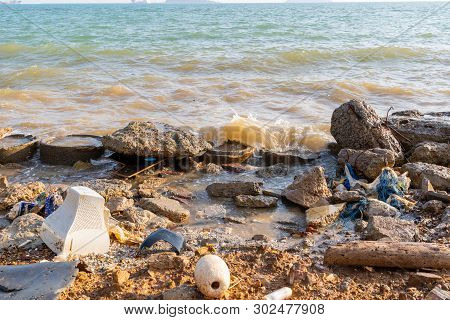 Electronic Waste And Foam Become Garbage On The Beaches And Birty Sea Water Near The Pier Strong Win