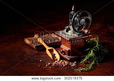 Vintage Pepper Mill With Various Peppers And Spices. Old Pepper Mill With Cooking Utensils, Spices A