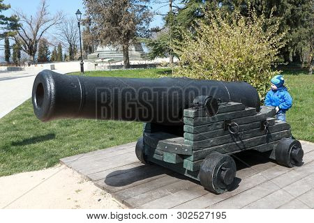 Child With Old Bomb Cannon On Malakhov Kurgan, Sevastopol