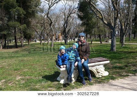 Family Sitting On Bench In Spring, Malakhov Kurgan, Sevastopol