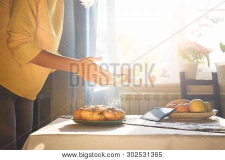 Housewife Sprinkle The Homemade Pie With Powdered Sugar. Homefood. Cook With Recipe From Internet. S