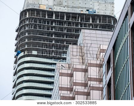 Cranes And Building Device On A Construction Site Of A Skyscraper In Downtown Toronto, Surrounded By