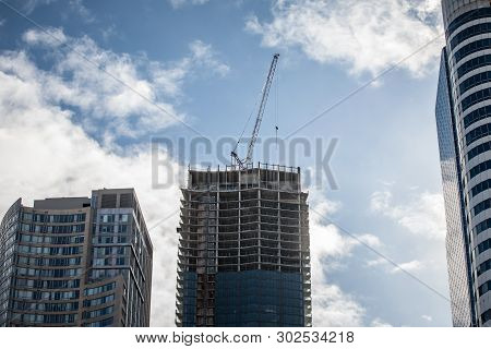 Cranes And Building Devices On A Construction Site Of A Skyscraper In Downtown Toronto, Surrounded B