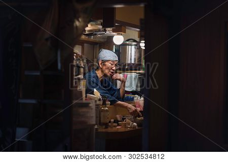 Osaka - November 02 2018: Staff In A Small Izakaya Restaurant (a Traditional Japanese Pub For After-