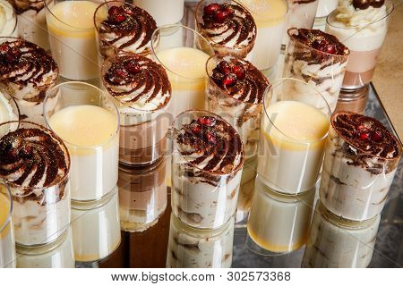 Closeup Assorty Of Cream Mousse Dessert In Plastic Cups