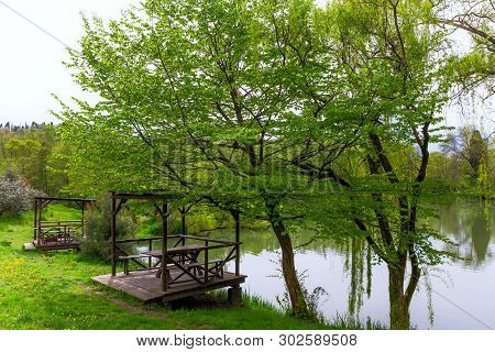 Landscape With Wooden Gazebos By The Lake