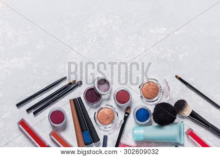 Makeup Products With Cosmetic, Brushes, Pencils, Eye Shadow, Hand Cream, With The Edge From The Phot