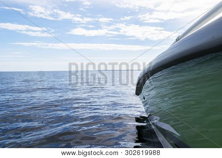 Side View Speeding Fishing Motor Boat With Drops Of Water. Blue Ocean Sea Water Wave Reflections Wit