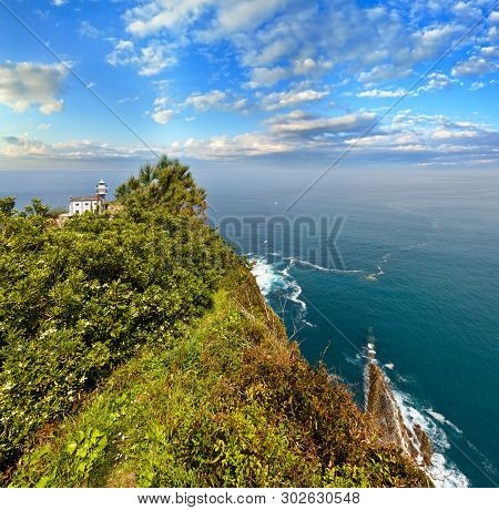 Getaria Lighthouse Is Located At The End Getaria Mouse (symbol Of Town), On Mount San Anton. Spain, 