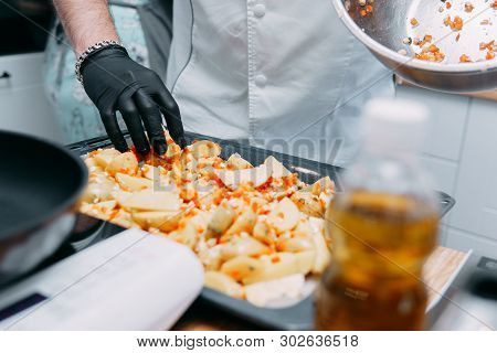 Cooking Fried Potatoes With Sweet Pepper On The Culinary Master Class. Potatoes Spread On A Baking S