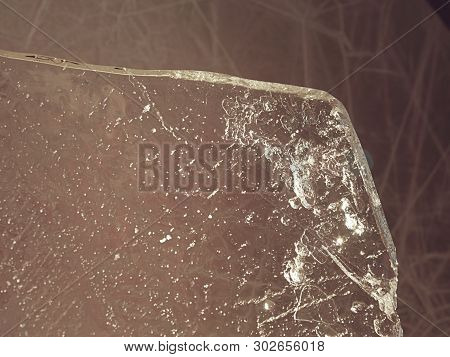 Thin Icy Board Against Strong Sun Light. In Ice Floe Are Visible Deep Cracks. Melting Of Arctic Ice