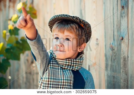 Child Boy Points To Something Up. Cute Kid. Advertising With A Child.