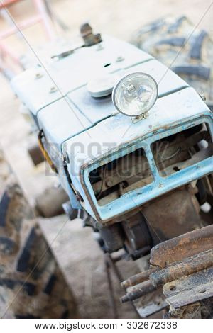 Abandoned rusty vintage walking Tractor. Small depth of field. headlight rusty vintage farm walking 