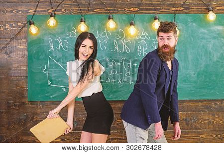 Student Lady Slapping On Teachers Buttocks With Book. Role Games Concept. Man With Beard Punished By