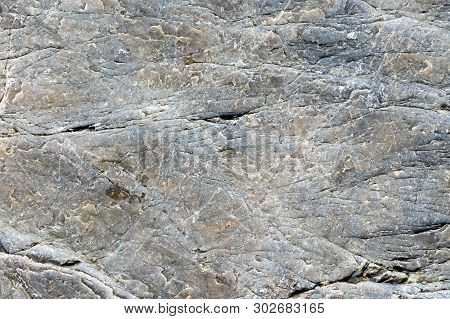 Close Up Macro View Of Cracked Stone Surface Grey Color. Detailed Nature Background Or Pattern Textu