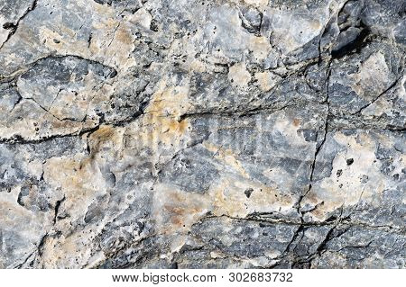 Cracked Stone Surface Grey And Brown Color. Detailed Nature Background Or Pattern Texture Taken In N